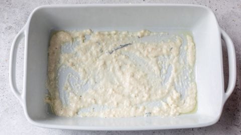 Bechamel sauce in bottom of baking dish.