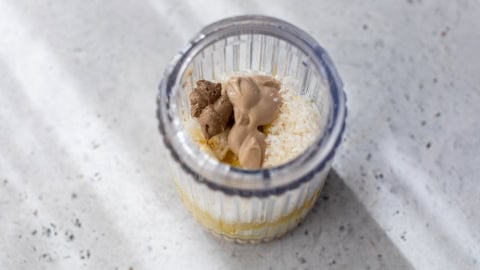 Ingredients for Caesar dressing in jar.