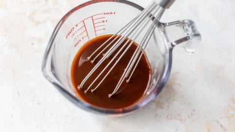 Stir fry sauce in liquid measuring cup with whisk.