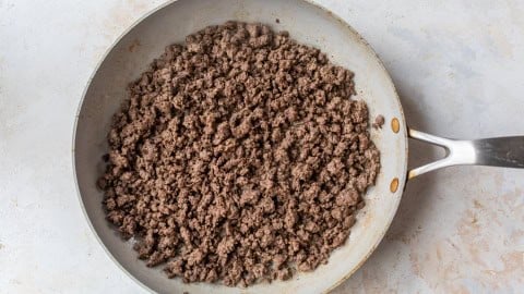 Ground beef browned in skillet.