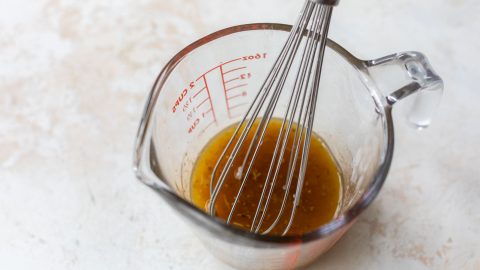 Whisk in measuring cup with Italian dressing.