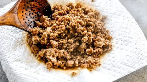 Crumbled breakfast sausage draining on paper towel.