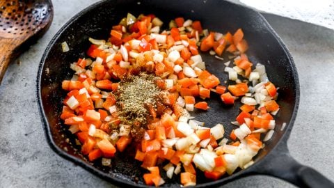 Sauteed peppers, onion, and seasonings in skillet.