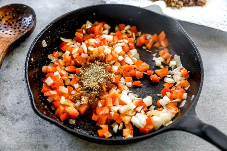 Sauteed peppers, onion, and seasonings in skillet.