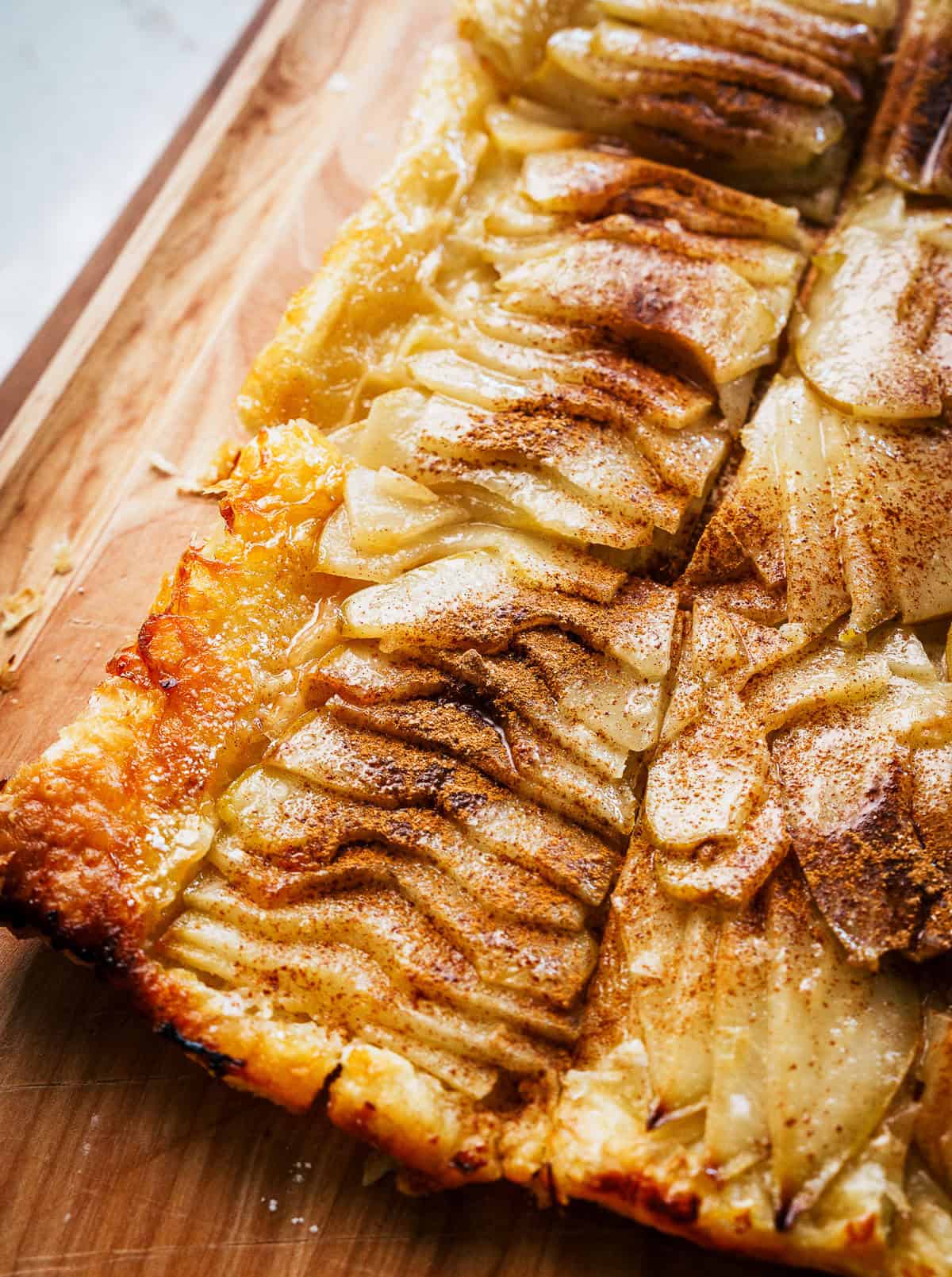 a pear tart with a puff pastry crust