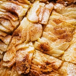 A close-up of a sliced pear tart