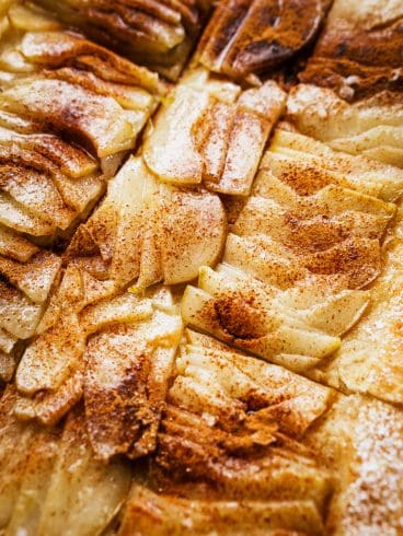 A close-up of a sliced pear tart