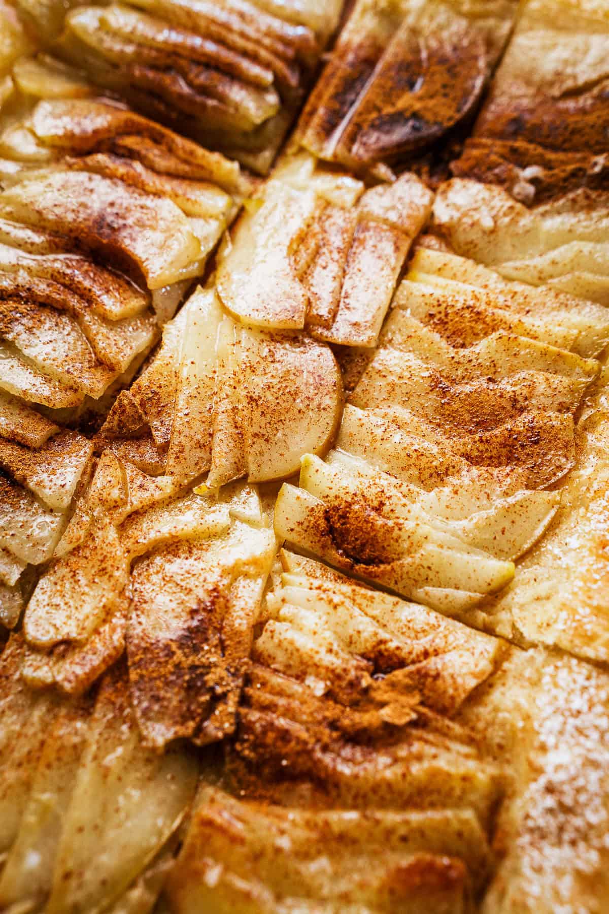A close-up of a sliced pear tart